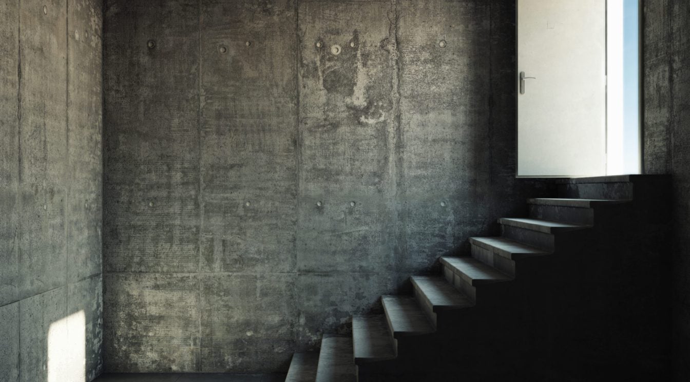 Interior room with concrete walls and stairs leading to the exit